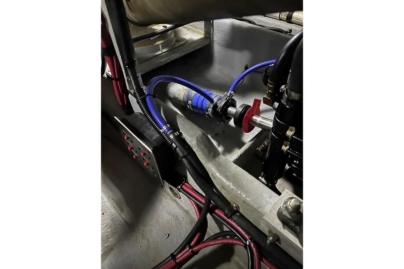 Slide: The Image of Engine compartment of a 1991 Sea Ray 390 Express Cruiser with visible wiring and components. - 41