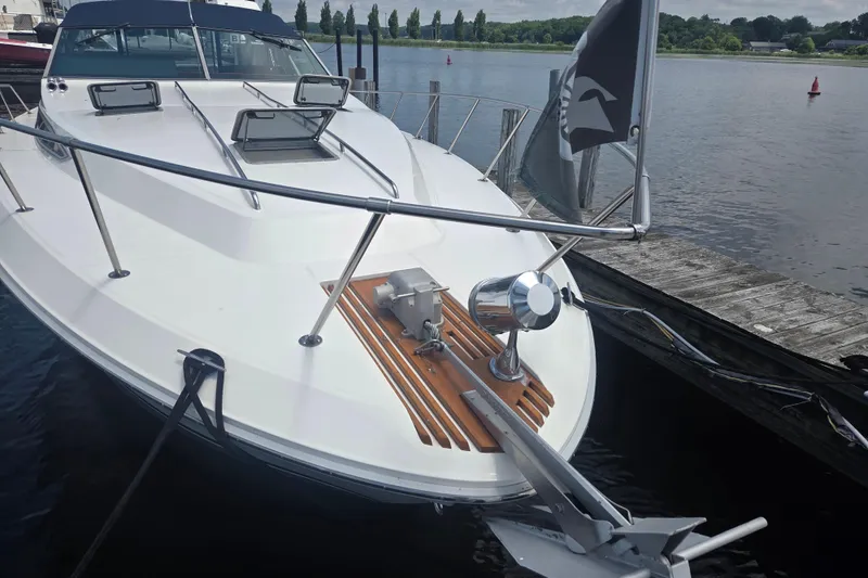 Slide: The Image of 1991 Sea Ray 390 Express Cruiser docked by a serene waterfront. - 47