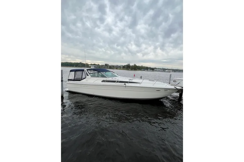 Slide: The Image of 1991 Sea Ray 390 Express Cruiser docked on a cloudy day. - 49