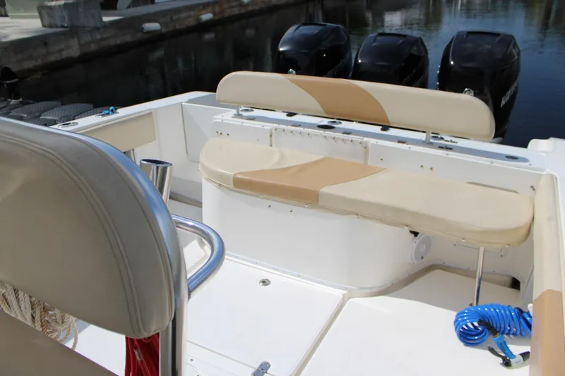Slide: The Image of 2007 Fountain 34 Center Console boat interior with seating and triple outboard motors. - 11