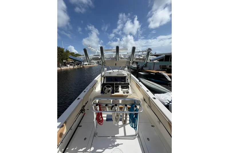 Slide: The Image of 2007 Fountain 34 Center Console boat docked under a clear blue sky. - 12