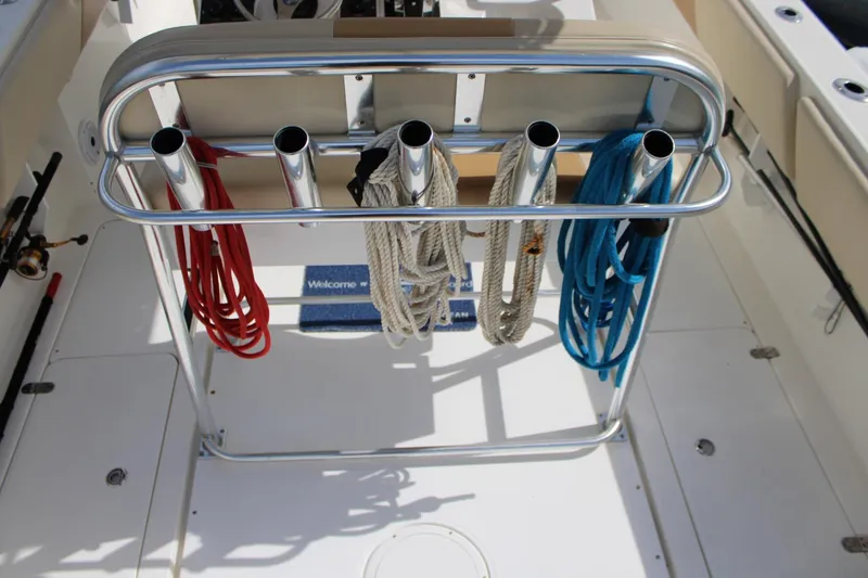 Slide: The Image of 2007 Fountain 34 Center Console boat with rod holders and colorful ropes on deck. - 13