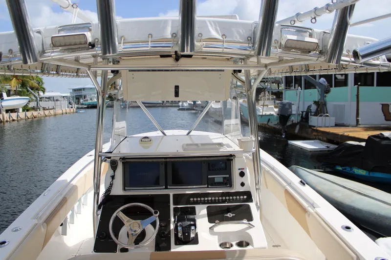 Slide: The Image of 2007 Fountain 34 Center Console boat interior with steering wheel and navigation equipment. - 14