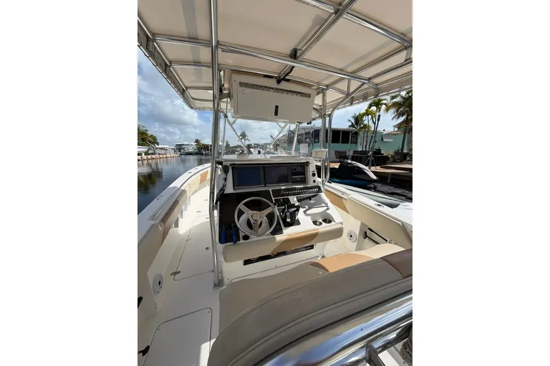 Slide: The Image of 2007 Fountain 34 Center Console boat interior with steering wheel and navigation equipment. - 15