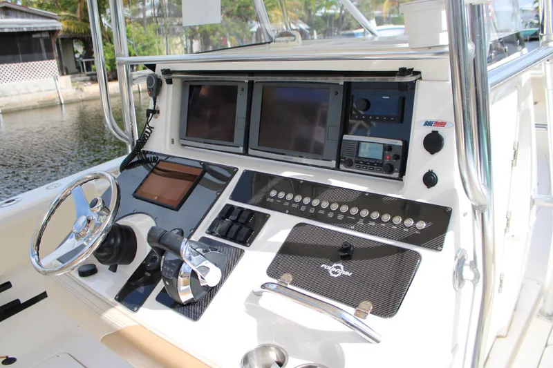 Slide: The Image of 2007 Fountain 34 Center Console boat dashboard with advanced navigation and control systems. - 16