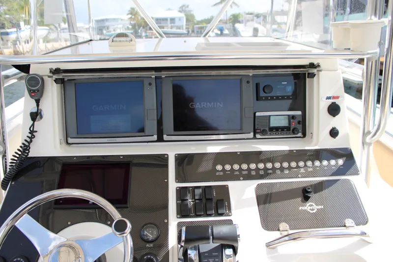 Slide: The Image of Center console of a 2007 Fountain 34 boat with Garmin navigation displays. - 17