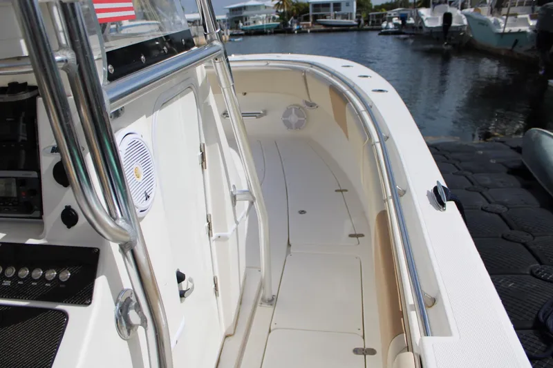 Slide: The Image of 2007 Fountain 34 Center Console boat docked, showcasing sleek design and spacious deck. - 18