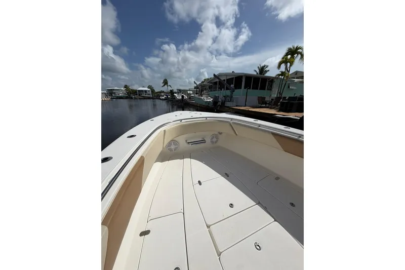 Slide: The Image of 2007 Fountain 34 Center Console boat docked under a partly cloudy sky. - 19