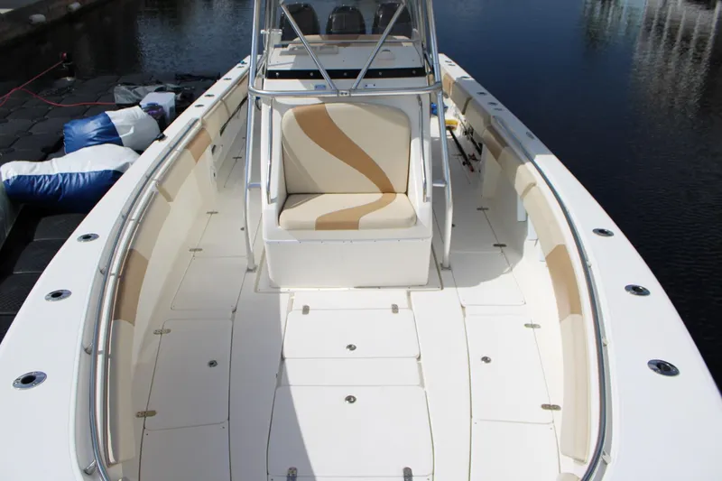 Slide: The Image of 2007 Fountain 34 Center Console boat with spacious deck and seating, docked by the water. - 21