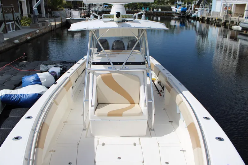 Slide: The Image of 2007 Fountain 34 Center Console boat docked in a serene canal setting. - 22
