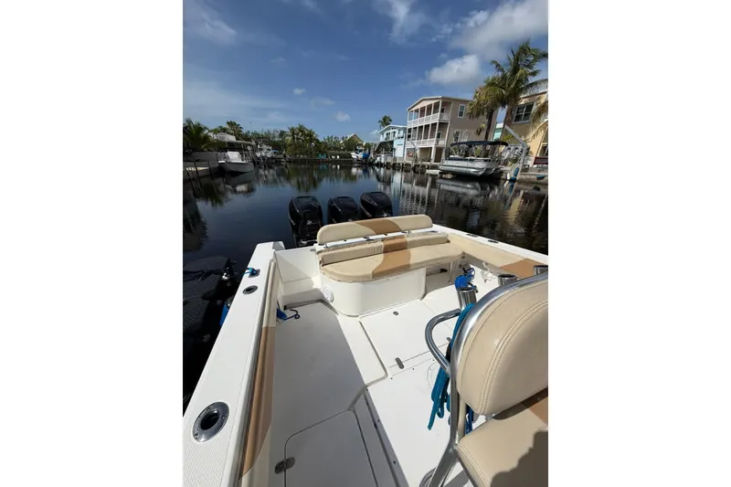 Slide: The Image of 2007 Fountain 34 Center Console boat docked in a scenic marina setting. - 9