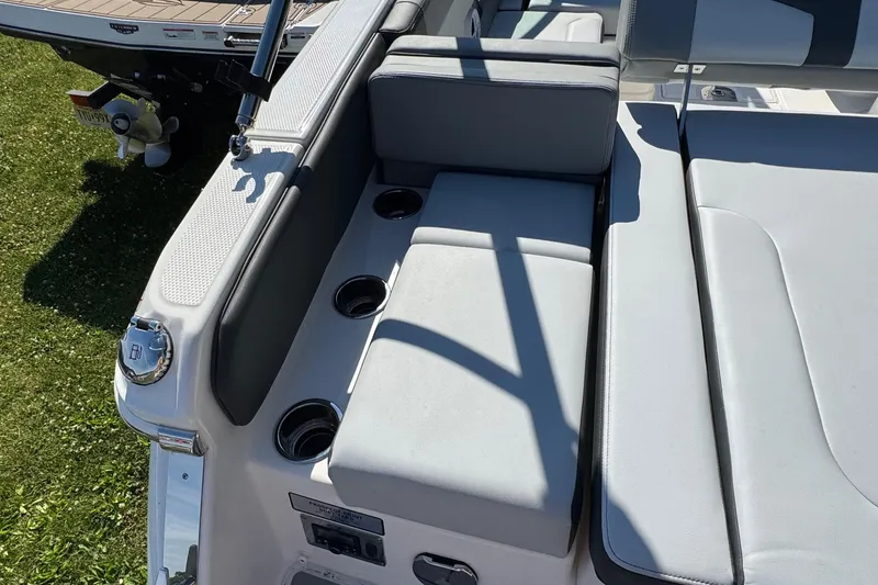 Slide: The Image of 2026 Chaparral SSX 4 boat interior with cushioned seating and cup holders. - 10
