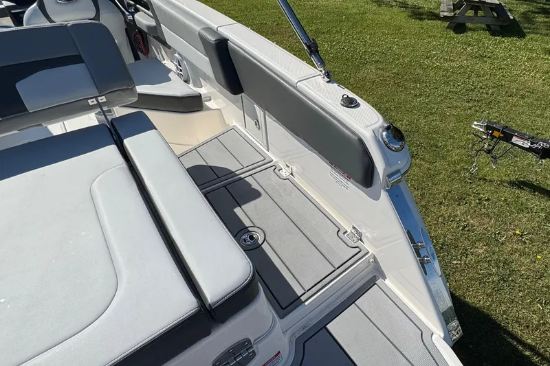 Slide: The Image of 2026 Chaparral SSX 4 boat interior with sleek seating and modern design on grass. - 12