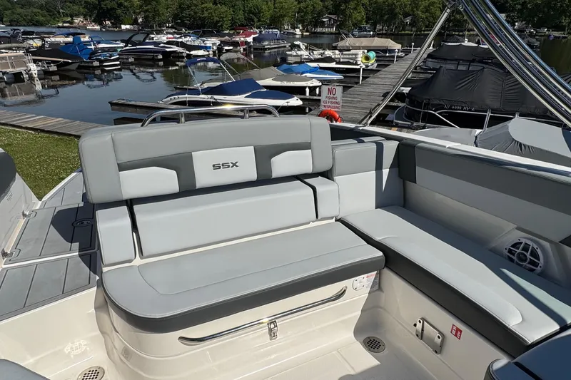 Slide: The Image of 2026 Chaparral SSX 4 boat interior with gray seating at a marina. - 15