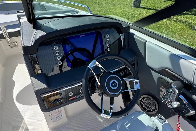 Slide: The Image of 2026 Chaparral SSX 4 boat dashboard with modern steering and control panel. - 22