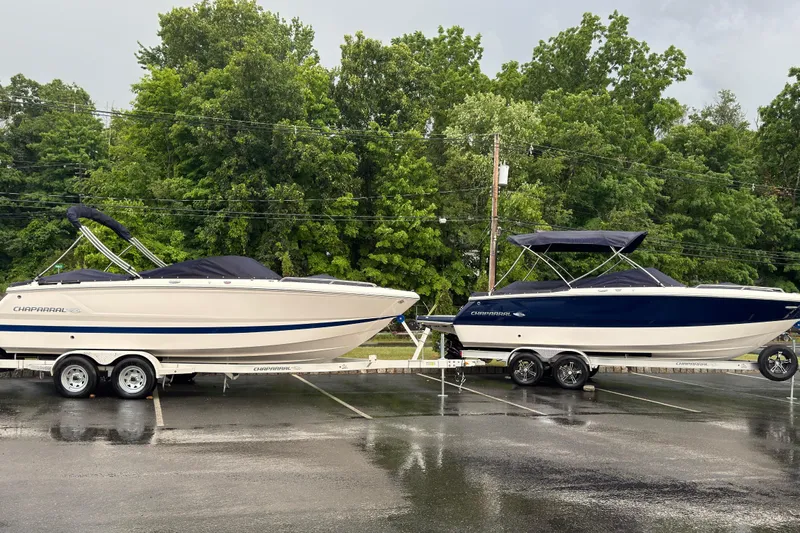 Slide: The Image of 2026 Chaparral SSX 4 boats on trailers in a parking lot, surrounded by trees. - 3