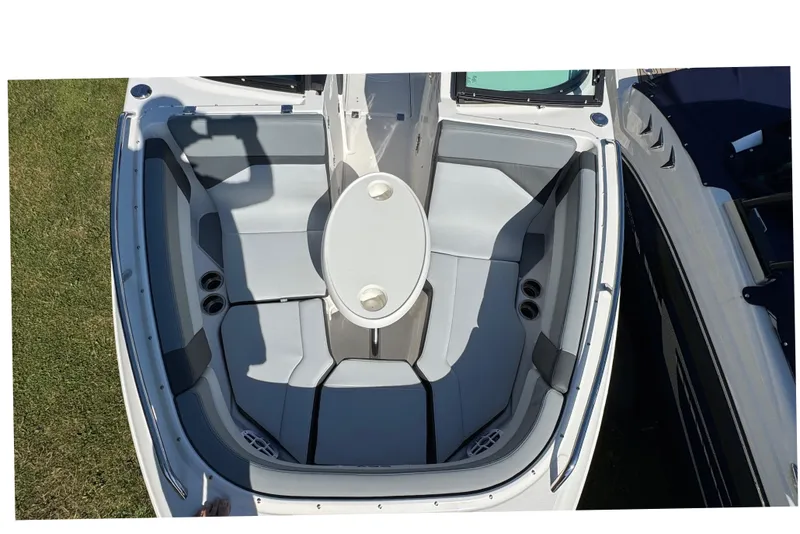 Slide: The Image of 2026 Chaparral SSX 4 boat interior with sleek seating and central table. - 30