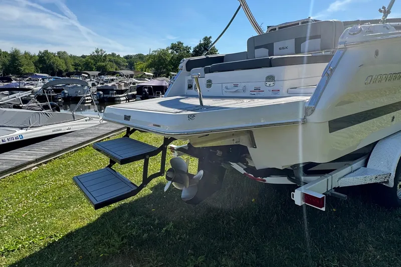 Slide: The Image of 2026 Chaparral SSX 4 boat at marina, featuring swim platform and ladder. - 6