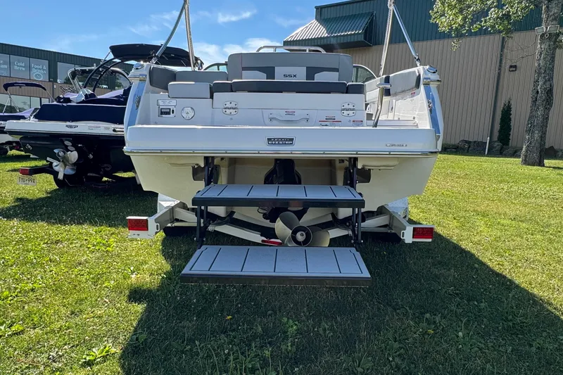 Slide: The Image of Rear view of 2026 Chaparral SSX 4 boat on grass, showcasing swim platform and propeller. - 7