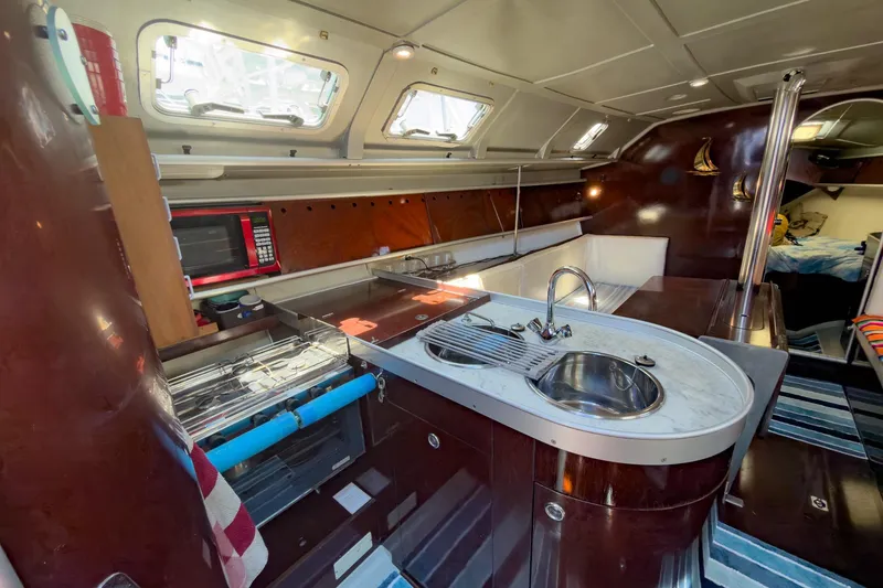Slide: The Image of Interior of 1993 Beneteau First 38 s5 yacht with modern kitchen amenities. - 11