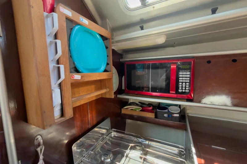 Slide: The Image of Galley of 1993 Beneteau First 38 s5 with microwave, dish rack, and stove. - 13