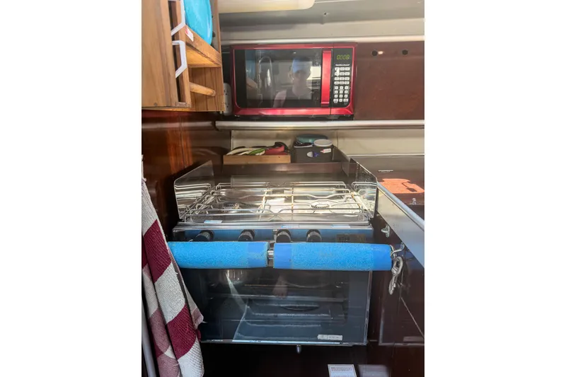 Slide: The Image of Galley kitchen in 1993 Beneteau First 38 s5 yacht with stove and microwave. - 14