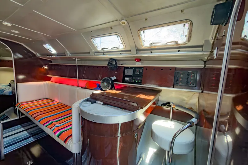 Slide: The Image of Interior of 1993 Beneteau First 38 s5 yacht with cozy seating and navigation area. - 17