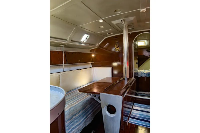 Slide: The Image of Interior of 1993 Beneteau First 38 s5 sailboat, featuring cozy seating and wooden table. - 18