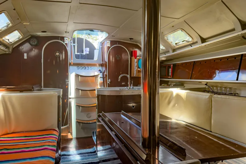 Slide: The Image of Interior of 1993 Beneteau First 38 s5 yacht, featuring cozy seating and modern amenities. - 19