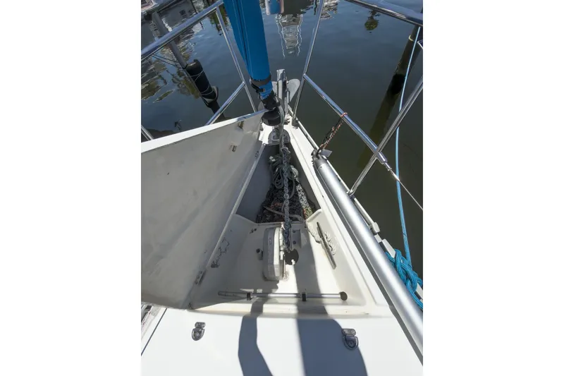Slide: The Image of Bow of 1993 Beneteau First 38 s5 sailboat with anchor and chain storage. - 26