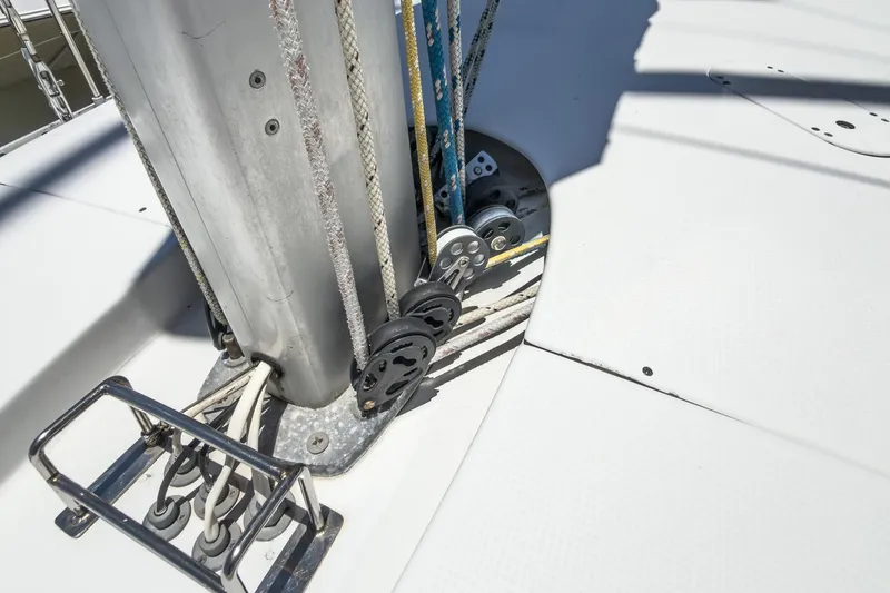 Slide: The Image of Deck rigging of a 1993 Beneteau First 38 s5 sailboat, featuring ropes and pulleys. - 27