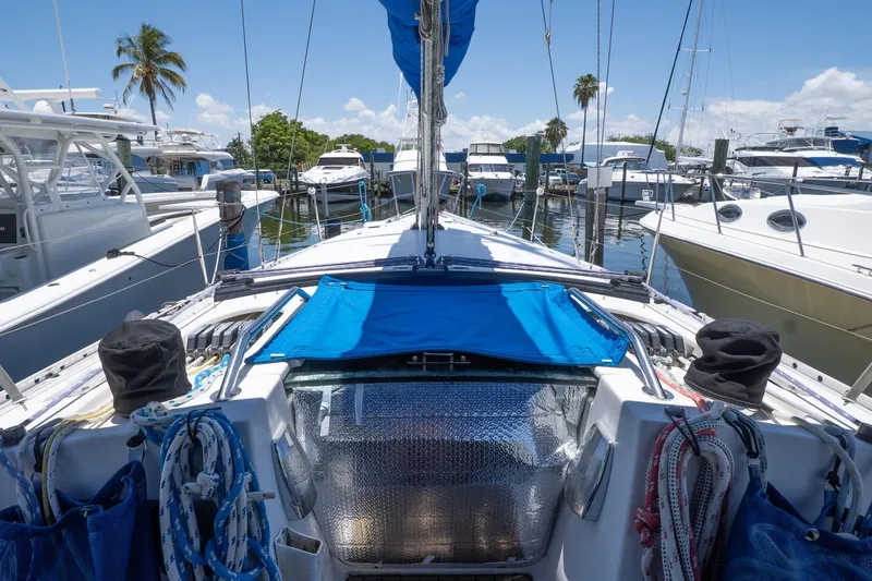 Slide: The Image of 1993 Beneteau First 38 s5 sailboat docked at marina, surrounded by other boats. - 3