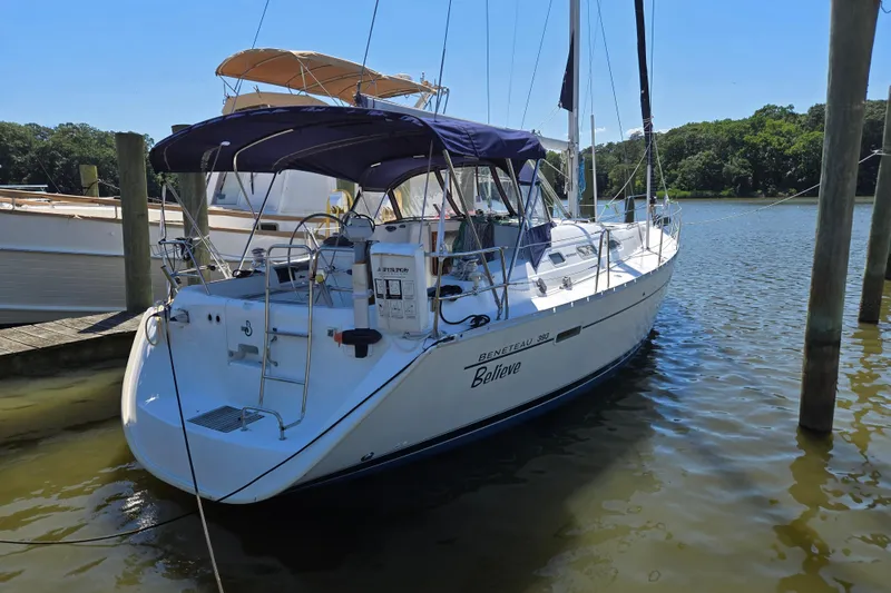 The Image of 2003 Beneteau 393 sailboat docked on a sunny day, featuring a sleek design and canopy. - 0