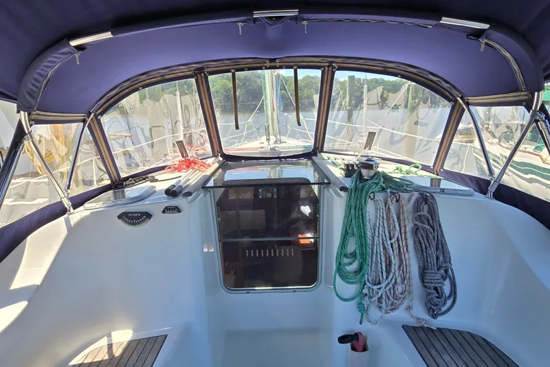 Slide: The Image of Cockpit of 2003 Beneteau 393 sailboat with ropes and canopy. - 10