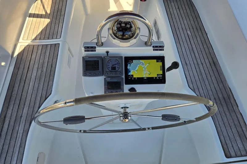 Slide: The Image of Steering wheel and navigation instruments on a 2003 Beneteau 393 sailboat. - 13