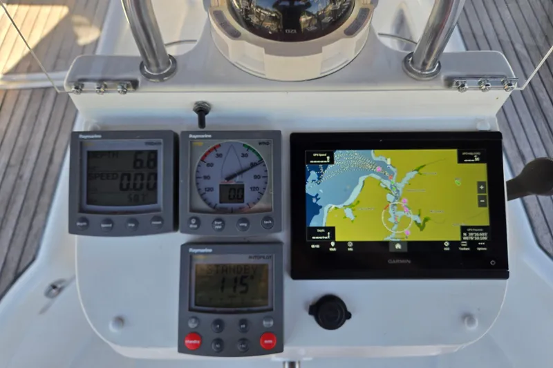 Slide: The Image of Navigation instruments on a 2003 Beneteau 393 yacht, featuring Raymarine displays and Garmin GPS. - 14