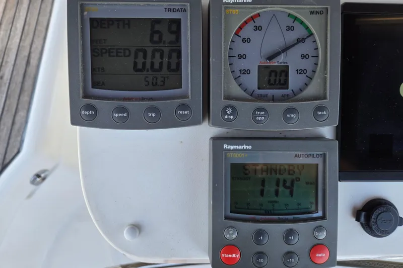 Slide: The Image of Beneteau 393 yacht control panel with depth, wind, and autopilot displays, 2003 model. - 15