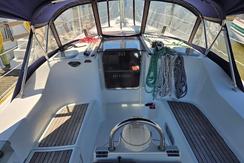 Slide: The Image of Cockpit of 2003 Beneteau 393 sailboat with ropes and steering wheel. - 2