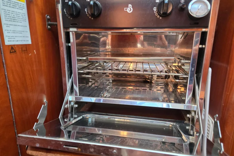 Slide: The Image of Stainless steel oven inside a 2003 Beneteau 393 yacht kitchen. - 25