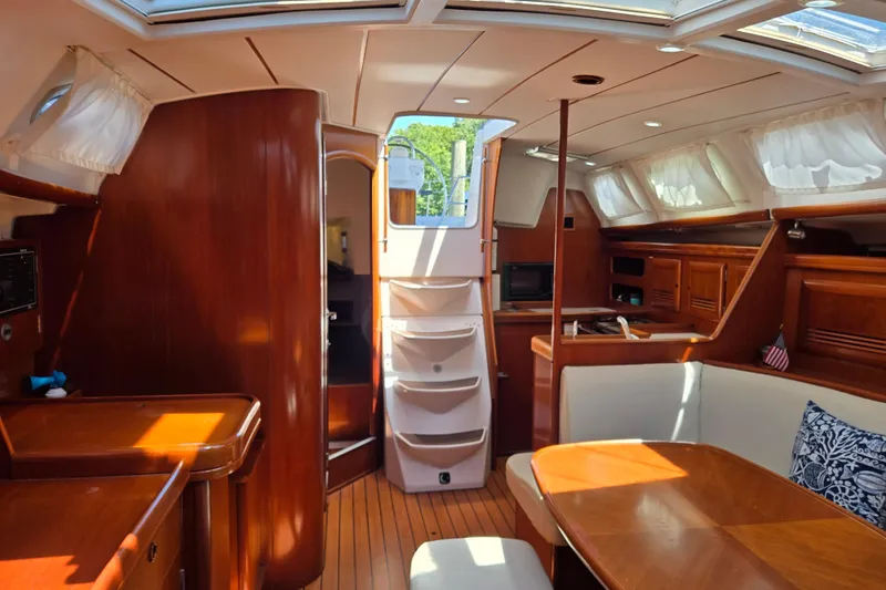 Slide: The Image of Interior of 2003 Beneteau 393 sailboat with wood finish and natural light. - 3