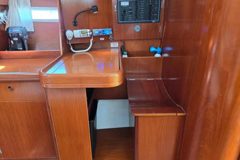 Slide: The Image of Interior of 2003 Beneteau 393 yacht with wooden cabinetry and navigation equipment. - 30