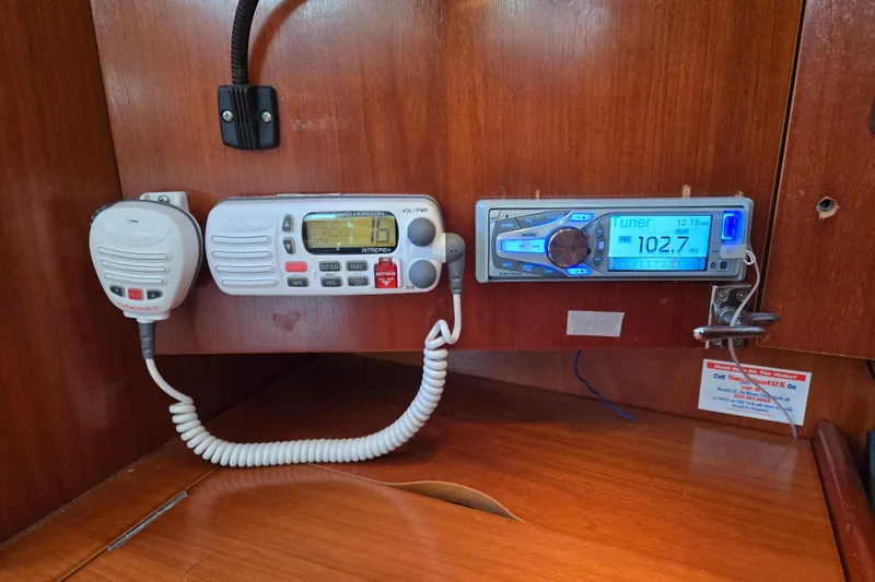 Slide: The Image of 2003 Beneteau 393 yacht radio and communication equipment on wooden panel. - 32