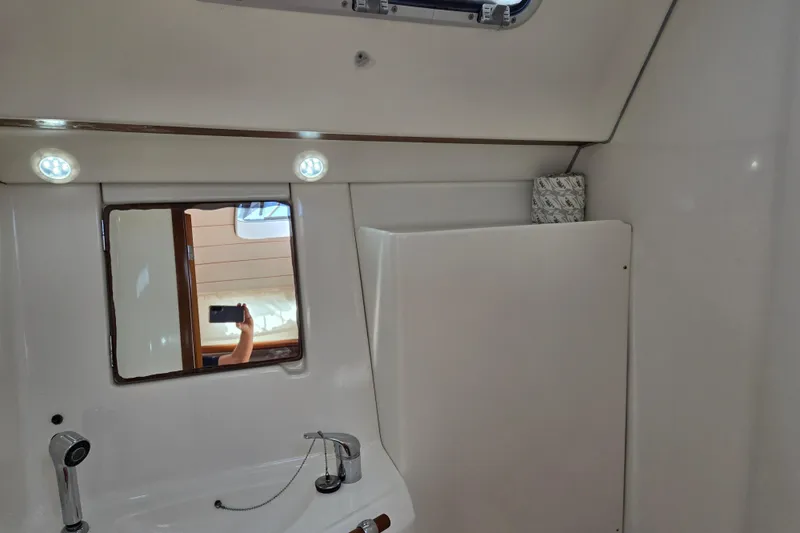 Slide: The Image of Interior of 2003 Beneteau 393 yacht bathroom with mirror and sink. - 36