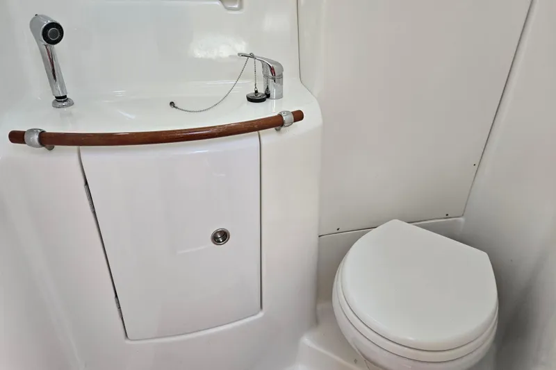 Slide: The Image of Bathroom interior of 2003 Beneteau 393 yacht, featuring sink and toilet. - 38