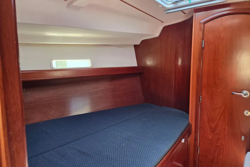 Slide: The Image of Interior cabin of 2003 Beneteau 393 yacht with wooden finish and cozy bed. - 39