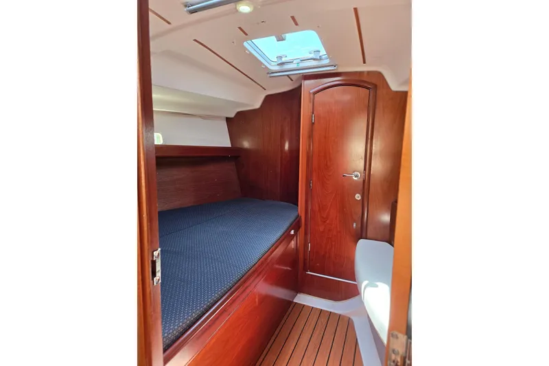 Slide: The Image of Cozy cabin interior of 2003 Beneteau 393 sailboat with wooden finish and skylight. - 40
