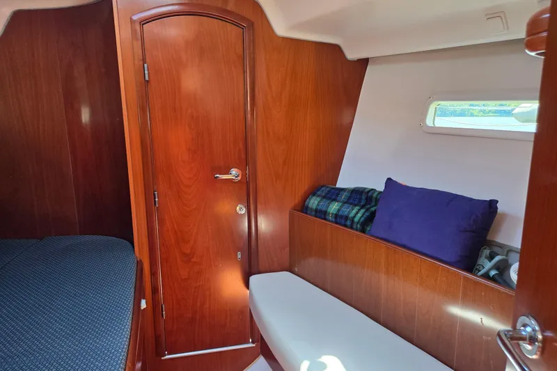 Slide: The Image of Interior cabin of 2003 Beneteau 393 sailboat with wooden finish and cozy seating. - 41