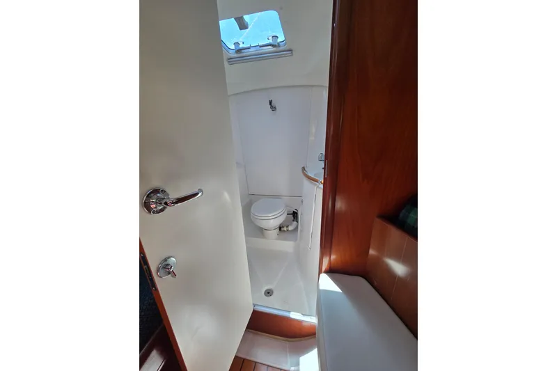 Slide: The Image of Interior view of a 2003 Beneteau 393 yacht bathroom with toilet and shower. - 46