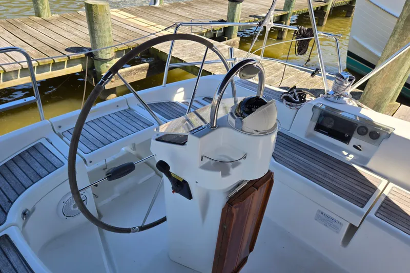 Slide: The Image of Cockpit of 2003 Beneteau 393 sailboat with steering wheel and navigation instruments. - 52