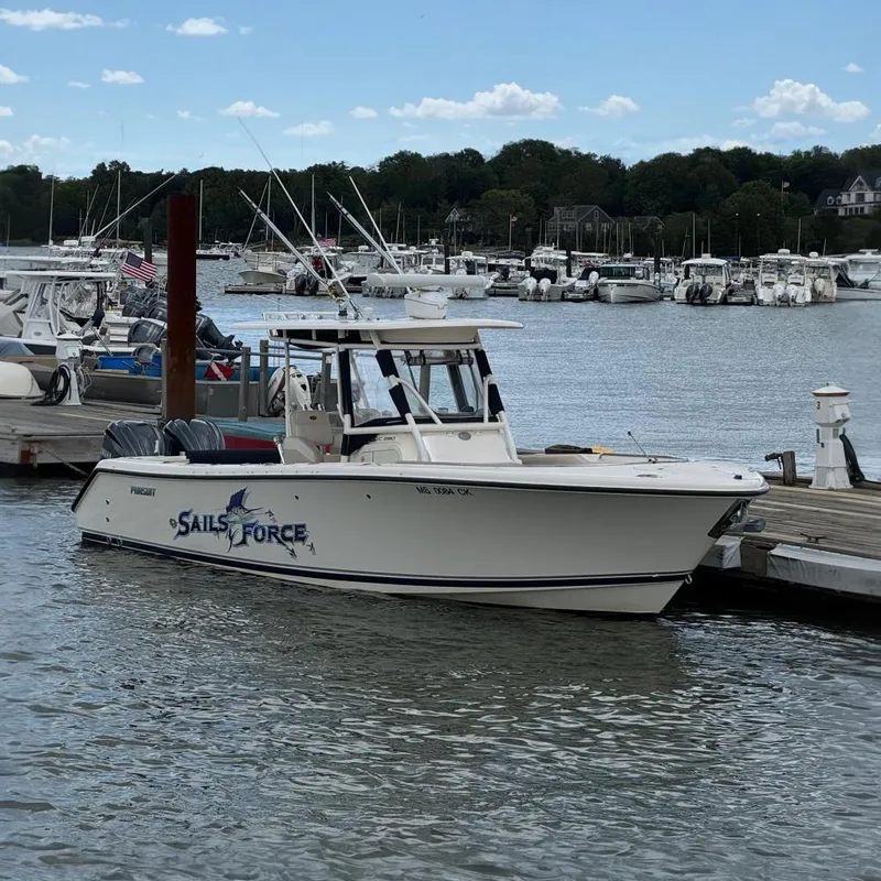 The Image of A 2011 Pursuit C 280 Center Console boat docked at a marina. - 0